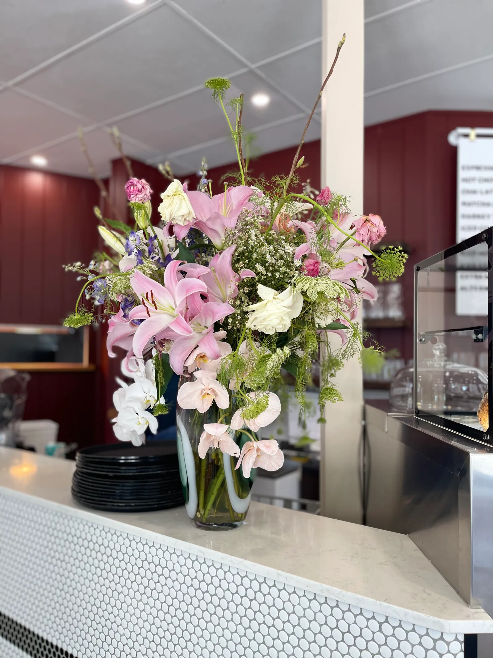 Fresh flowers on the front counter with the cabinet behind
