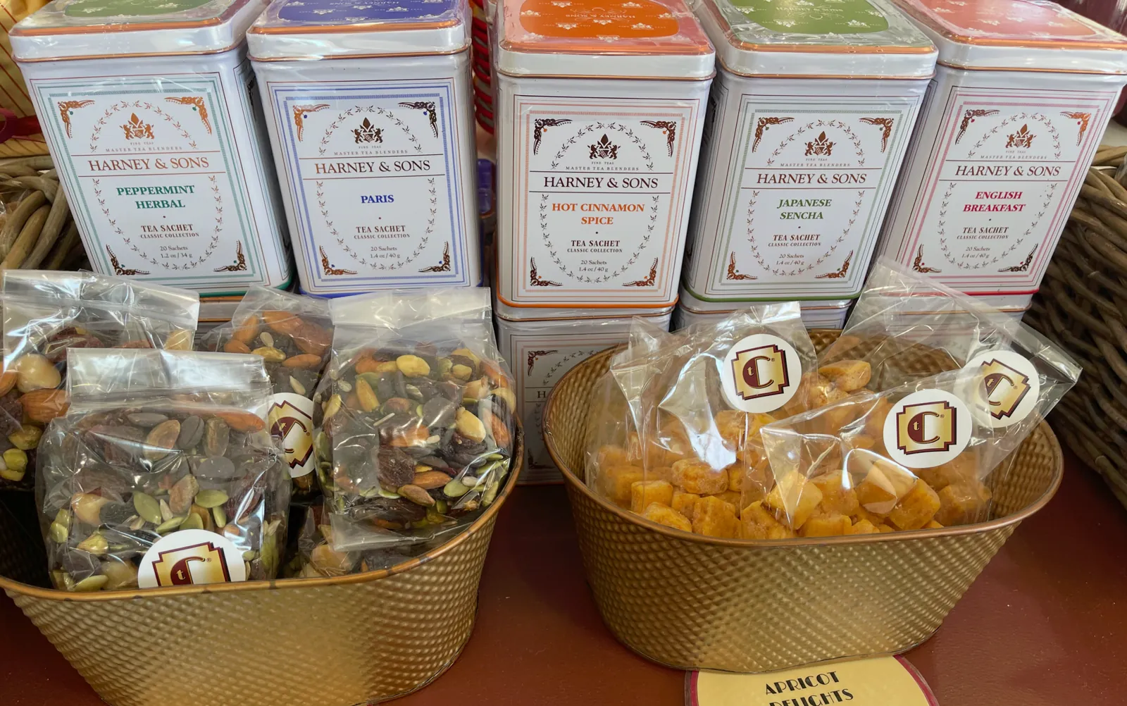 Tea tins and packaged treats on the gift shelf