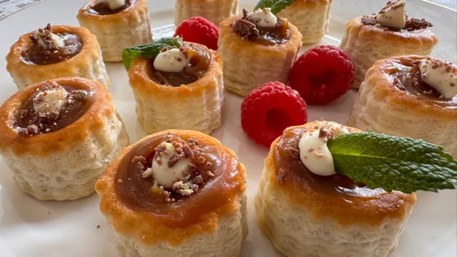 Pastry tartlets topped with raspberries and mint